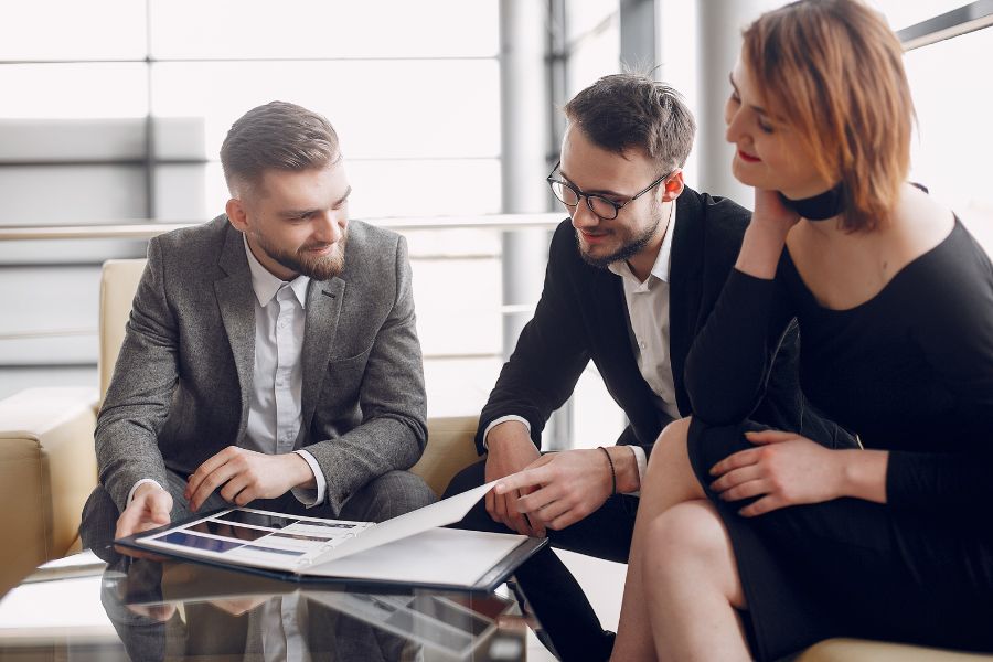 Salesman having a conversation with his customers in the office